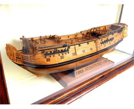 A model of HMS Strafford 1714, a 4th Rate Ship Of The Line in the British Navy, in a glazed and stained pine case, 42 x 93 x 