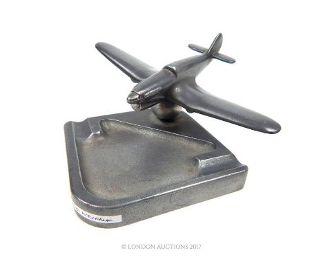 A white metal Kittyhawk model with ashtray. 