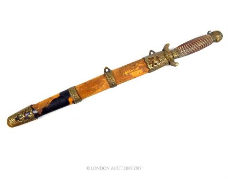 A Chinese dagger, with brass guard and pommel, wooden grip and scabbard; blade length 16cm.