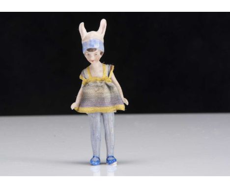 A rare Hertwig all-bisque dolls’ house long legged girl with bunny ears, with painted features, moulded blue and pink painted