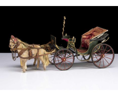A late 19th century French tinplate Victoria carriage, painted dark green with gold lining, oil-cloth hood with pink lining a