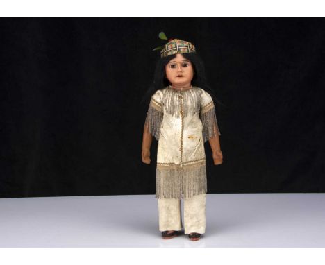 An Armand Marseille Native American Indian brave,  with light brown bisque head, fixed brown class eyes, heavy brow and promi