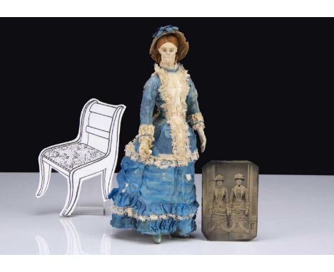 A late 19th century hand-stitched cloth doll, with bright blue glass bead eyes, stitched eyeline, brows and mouth, reddish br