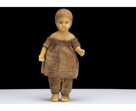 A rare small beeswax anatomically correct toddler boy doll circa 1815, with inset bead glass eyes, slightly parted down turne