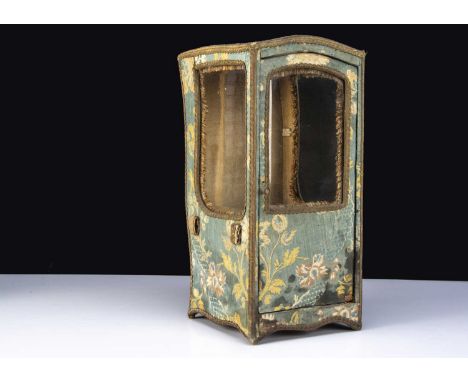 A 19th century doll’s sedan chair, covered in blue silk brocade, three glass windows, opening front door, loops for inserting