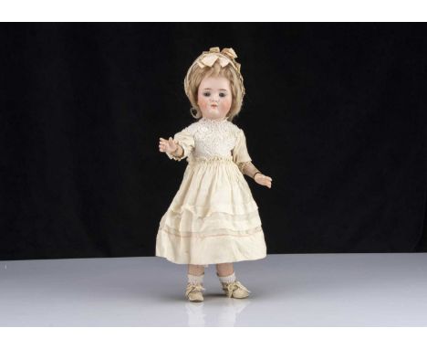 A rare German character doll marked 484, with blue sleeping eyes, light brown feathered brows, closed slightly smiling mouth 