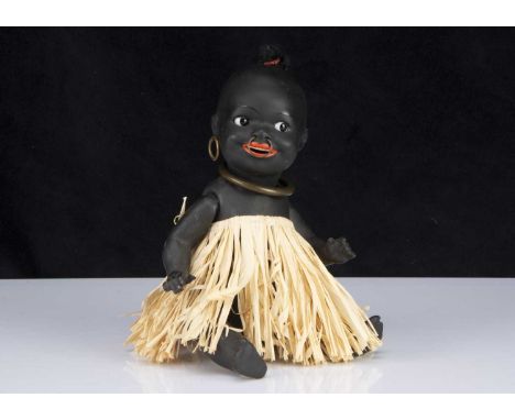 An Ernst Heubach  463 painted bisque black baby, with dark side glancing glass eyes, wide open smiling mouth with full lips, 