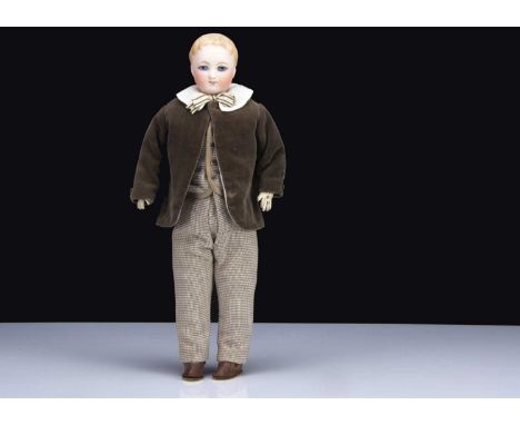 A rare German bisque shoulder-head boy doll, with blue painted upward glancing eyes, black eyeliner, light brown brows, pink 