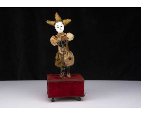 A late 19th century French white faced clown automaton with magic ring trick,  probably Roullet & Decamps with white bisque h