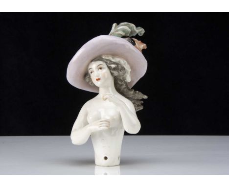 A fine half-doll in elaborate hat,  probably by Dressel & Kister, her head slightly turned to right with light brown painted 