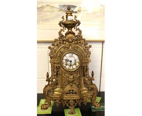A Modern Gilt Metal Striking Mantel Clock, the elaborate case with mask and shell motifs, 60cm high