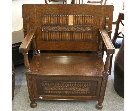 A Carved Oak Monks Bench, first half 20th century, on bun feet, 91cm by 48cm by 75cm