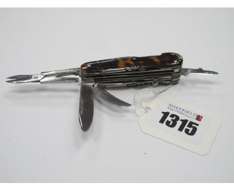 A XIX Century Multi Tool Pocket Knife, with turtle scales, over twenty tooling implements 6.2cm when closed.