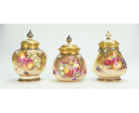 Three Royal Worcester hand painted pot pourri jars with reticulated lids. Two signed N Creed, one J Read.13.5 to 11.5 cm high
