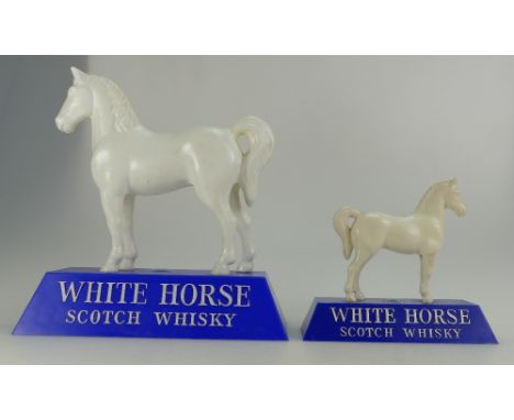 White Horse plastic advertising figure on blue base, height 23cm together with similar smaller item. (2) 