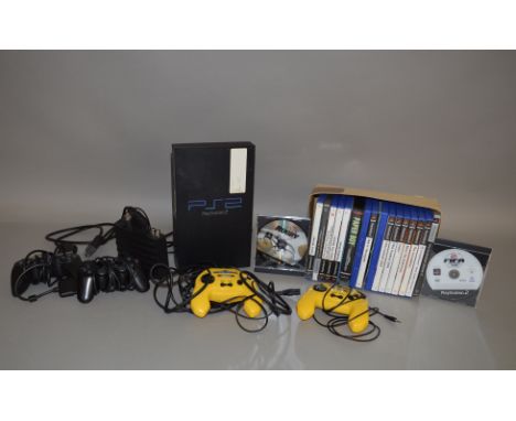 A Playstation 2 console, with power leads, four controllers and a quantity of games, together with Sega Mega Drive Paper Boy 