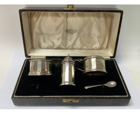 A cased hallmarked silver cruet set together with a hallmarked silver cased fork and spoon christening set. (B).