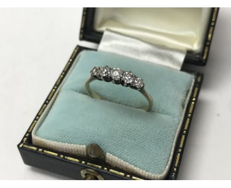 An 18ct yellow gold and platinum 5 stone brilliant cut diamond ring, size O.