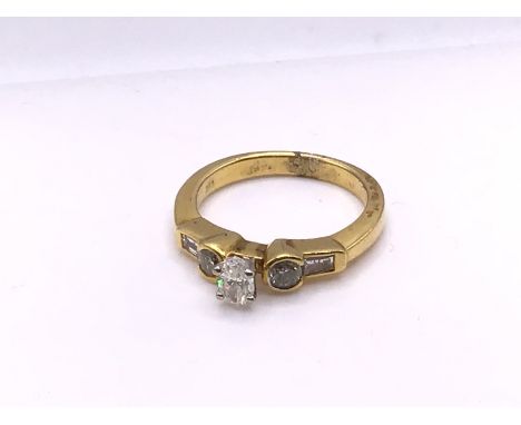 An 18ct yellow gold oval, brilliant and baguette cut ring, Size M, (A).