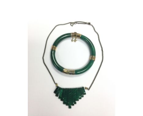A malachite bangle with silver gilt banding together with a malachite pendant (2).