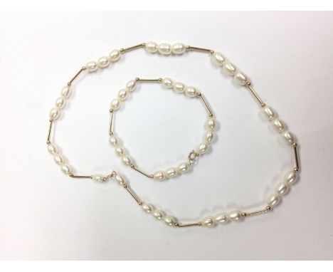 A cultured oval pearl and 9ct gold necklace and matching bracelet.