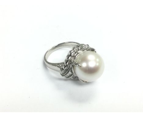 A certificated large platinum cultured pearl ring with baguette R/C diamonds. Diamonds approx 0.85ct, approx 11.8g and approx