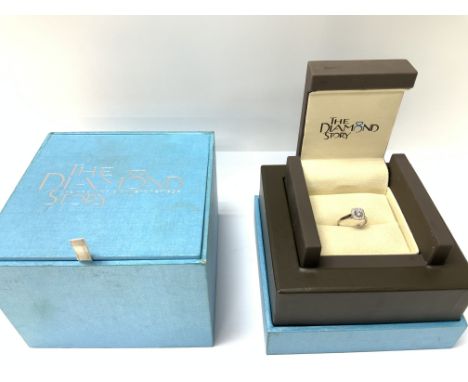 An boxed and certificated 18ct white gold ring set with a central 0.30ct centre stone and surrounded by 0.22ct twt, G/H colou