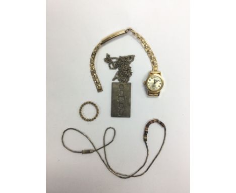 A small bag of oddments comprising a gold ring, silver ingot, watch etc.