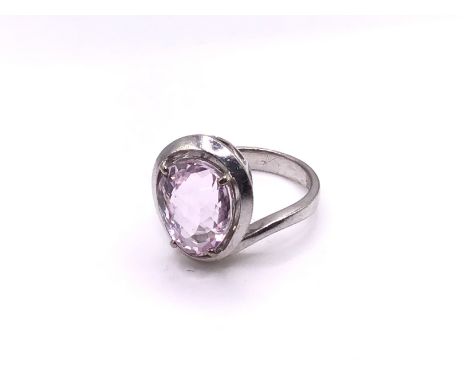 A 14ct white gold ring set with a single 6.29ct pale oval cut amethyst, Size L, (A).