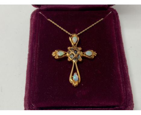 A 14ct gold Fratelli Coppini cross set with Opal and a faceted aquamarine. Approximately 8.3g (A).