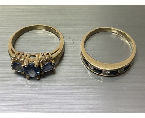 An 18ct (possibly Ceylon sapphire) and diamond ring, M, together with an 18ct half eternity set with a row of sapphire and di