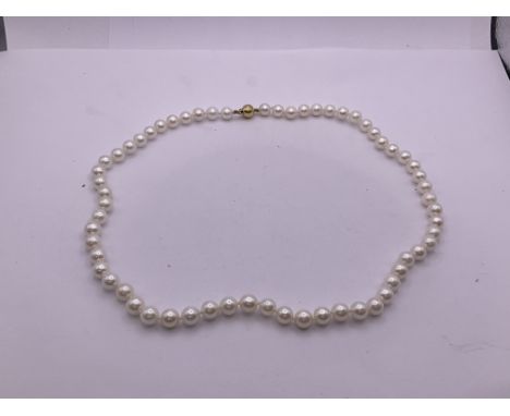 A pearl necklace with an 18ct gold clasp