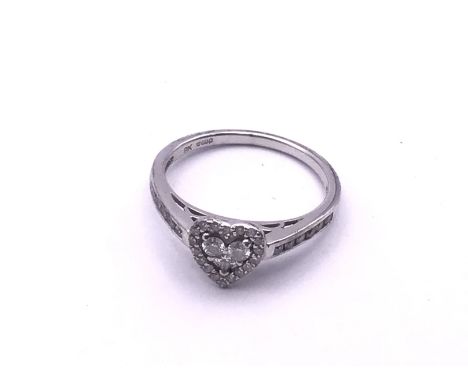 A 9ct white gold and diamond heart design ring. (A).