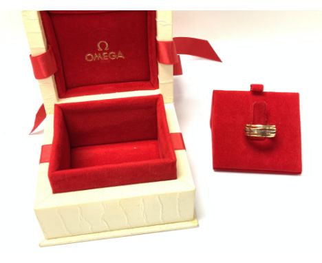 A 3 colour 18ct gold Omega band with original box, serial number. 14601851. Size K, approximately 10.1g (B).