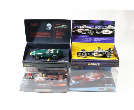 4 2000's issue Scalextric slot racing cars. A Spanish produced Scalextric 2002 Ferrari? Formula One racing car. Pus a McLaren