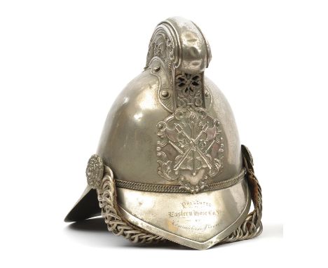 A fire officer’s presentation WM Merryweather pattern helmet,  with front peak and large back peak, comb embossed with a drag