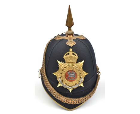 A post-1902 officer’s blue cloth spiked helmet of The Queen’s (Royal West Surrey Regiment), brass peak binding, top mount and