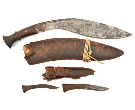 An old kukri,  swollen blade 14”, with short twin fullers, darkwood grip with raised central band, and sheet iron top to pomm