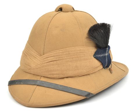 A khaki tropical helmet of a Scottish Regiment, silk puggaree with diamond shape piece of tartan cloth on either side, leathe