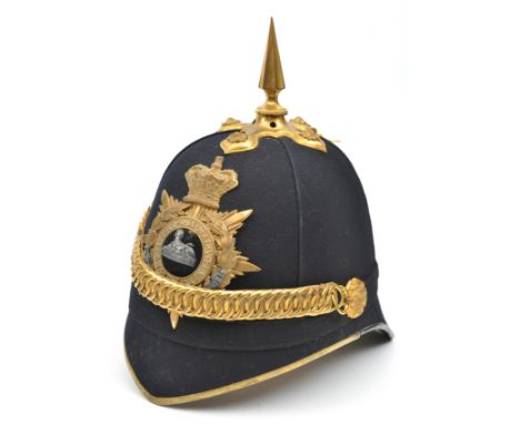 A Victorian officer’s blue cloth spiked helmet of The South Staffordshire Regiment, brass peak binding, gilt top mount and sp