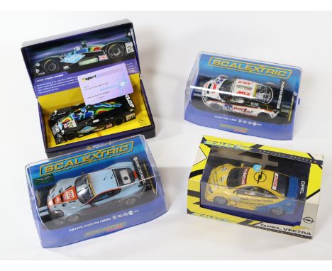 4 2000's issue Scalextric slot racing cars. Aston Martin DBR9 (C2965) in weathered light blue, RN009. Audi R8 Le Mans (C3232)