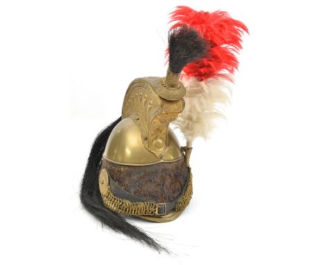 A mid 19th century French cavalry trooper’s brass helmet,  edge binding to front and back peaks, fur turban, comb with orname