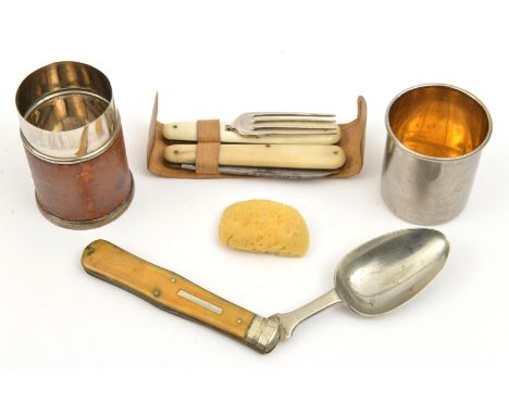 An assembled companion trousse:  folding fork with small corkscrew, and folding knife, in leather slip, folding dessert spoon