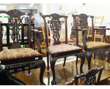 A set of eight 19th Century Chippendale style dining chairs (including two carvers) on carved cabriole legs and claw and ball
