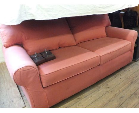 A modern pink upholstered sofa bed