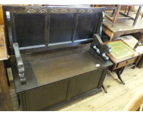 An Oak monk's bench with lion carved ends and small sofa table