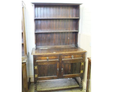 An Oak shelf back dresser with two drawers and two cupboards below