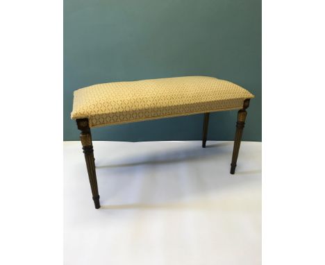 A regency sofa stool, supported upon fluted legs with an original gold leaf design 