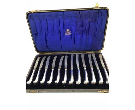 A box set of 12 London silver handled butter knifes, The handle is in the shape of a pistol grip. Comes with a fitted box. Ma