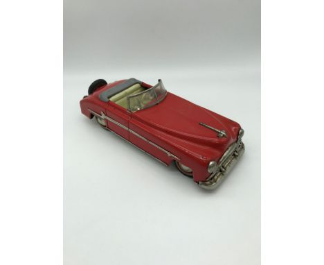 Vintage Distler metal windup clockwork red car made in US Zone Germany. Measure 7x26x9cm 